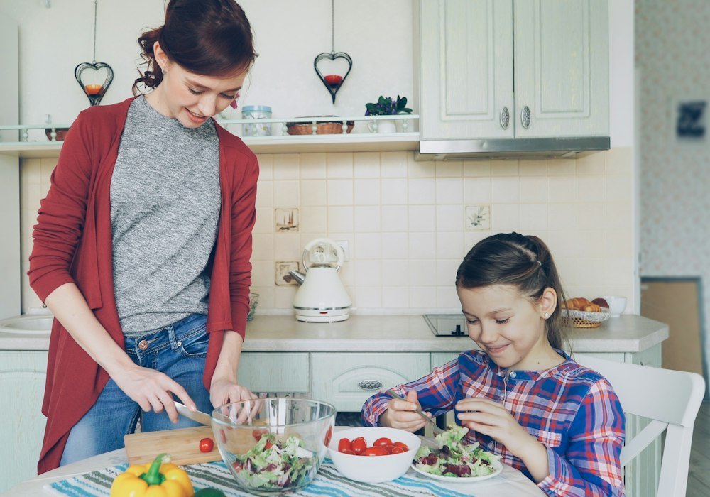 Mother and daughter preparing a healthy salad